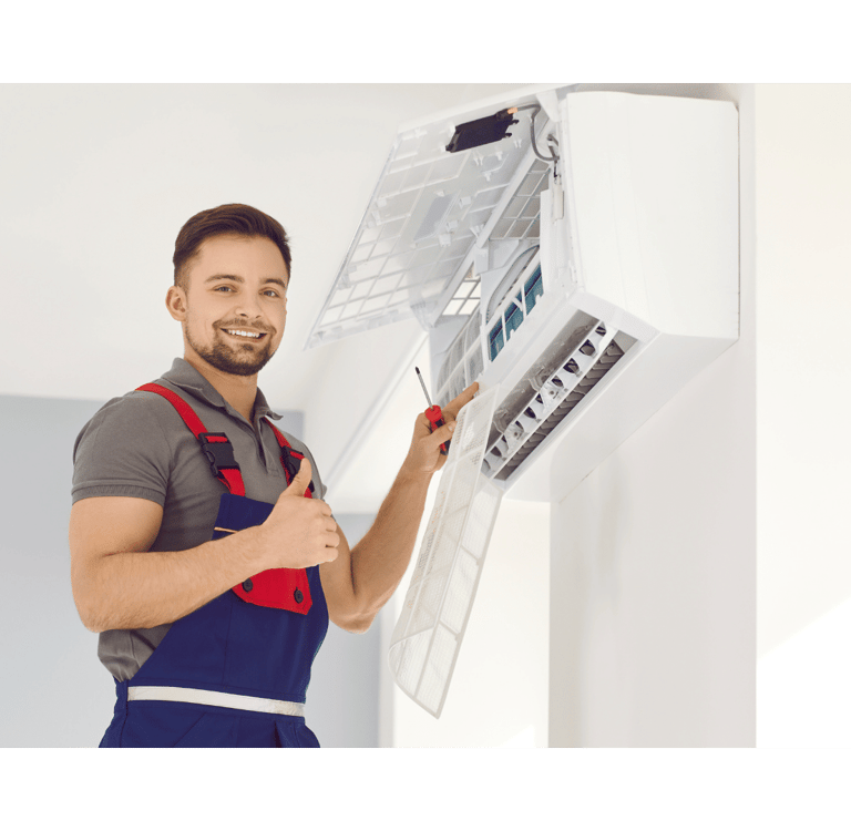 a man in overalls and overalls holding a large air conditioner