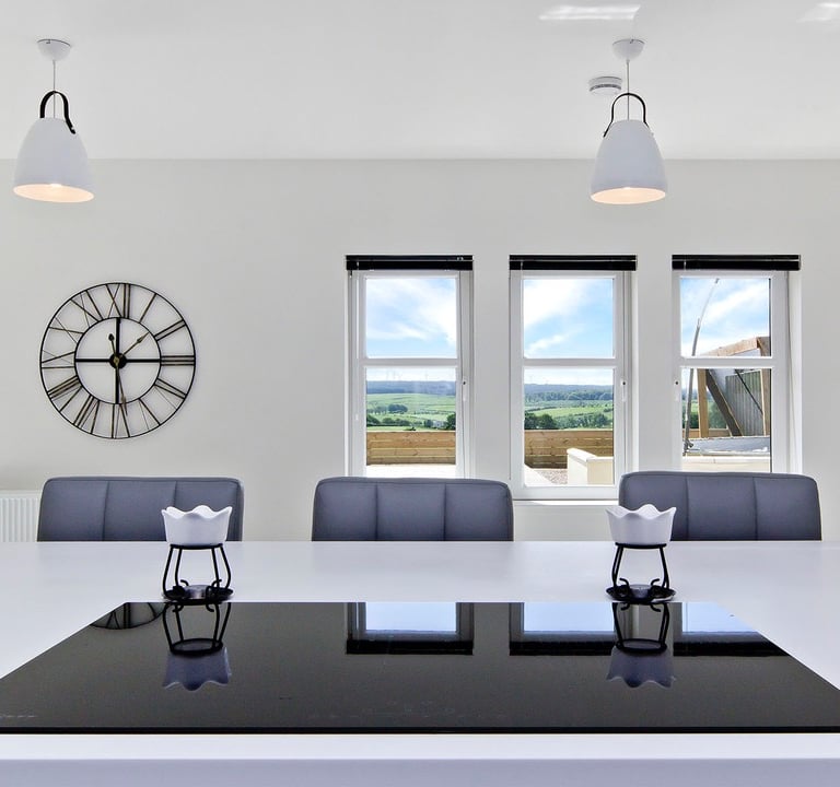 Modern kitchen design with integrated appliances  and a spacious island.