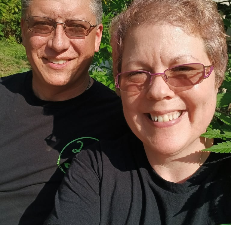 a man and woman sitting in front of a hemp plant