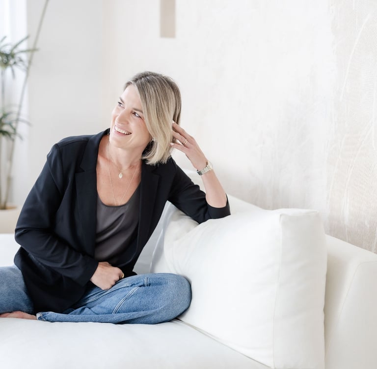 Psychotherapist in Singapore Yvonne smiling, soft lighting, laughing.