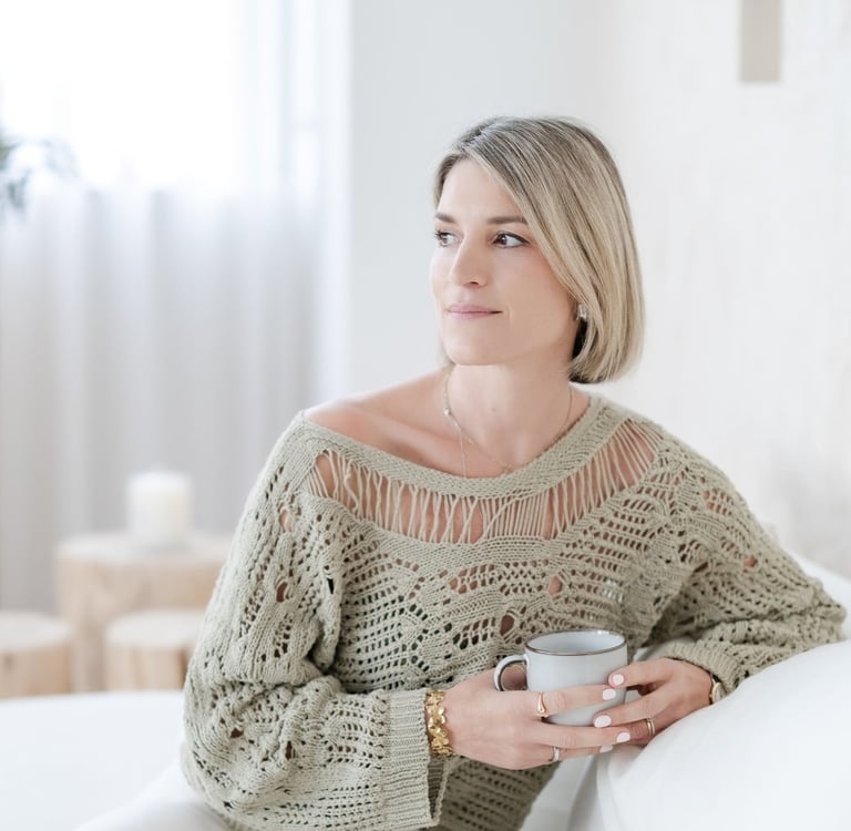 Yvonne, psychotherapist, having a coffee and looking calm, friendly and reflective