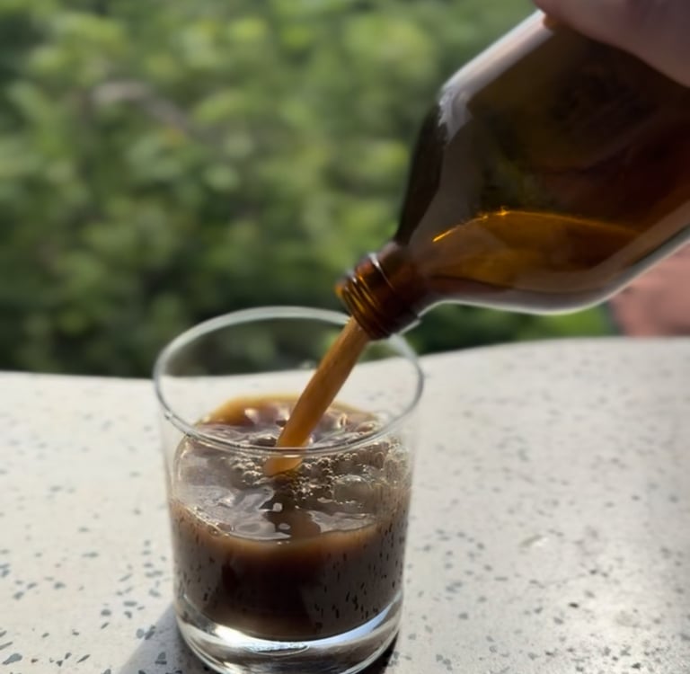 Ayurvedic medicine tonic being poured in a glass