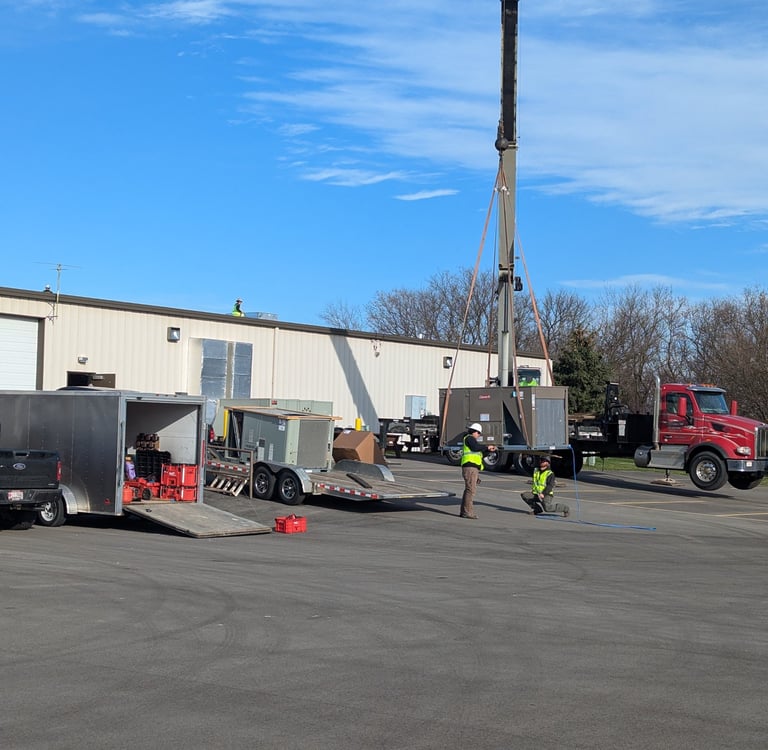 Commercial roof top unit being lifted by a crane by our TRAG HVAC team. No job too big or too small.