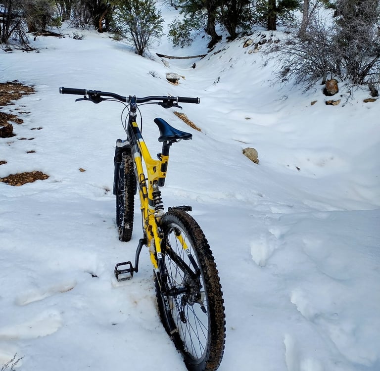 Mountain bike parked in deep snow on a winter trail in the San Bernardino mountains