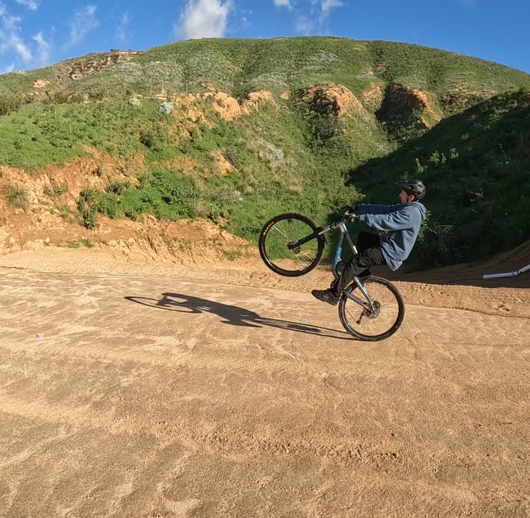 mountain biker doing a wheelie