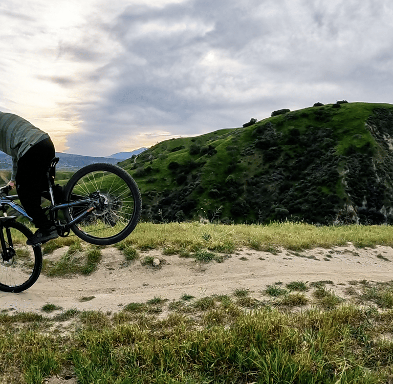 Mountain biker about to set the rear wheel down after a stoppie