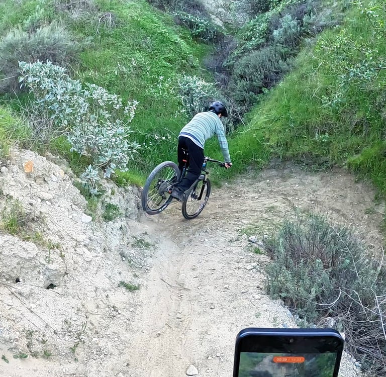 Mountain biker initiating a stoppie before a tight switchback by applying controlled front brake pre