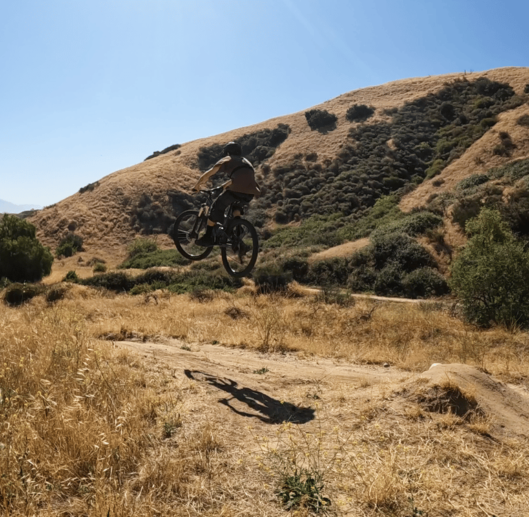 mountain biker in the air off a jump