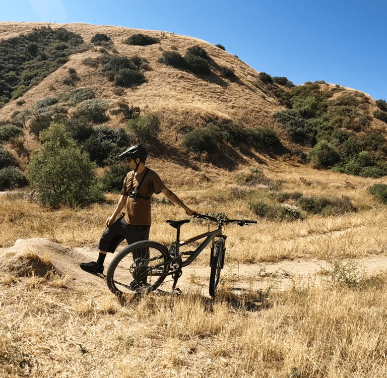 mountain biker looking at a jump trying judge how much speed they need to clear the gap