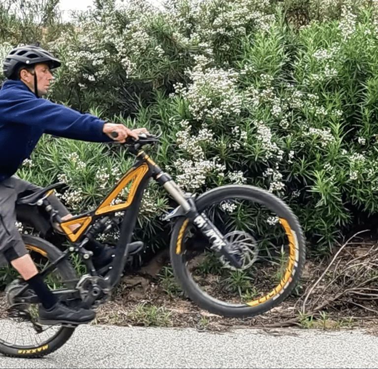 mountain biker lifting front wheel for a seated manual