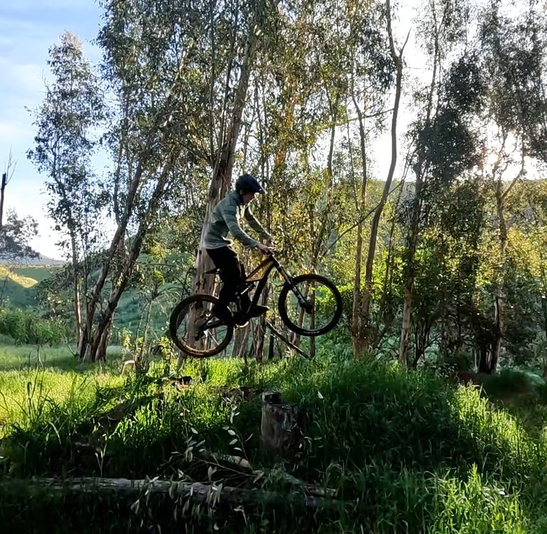 mountain biker in the air off a small jump