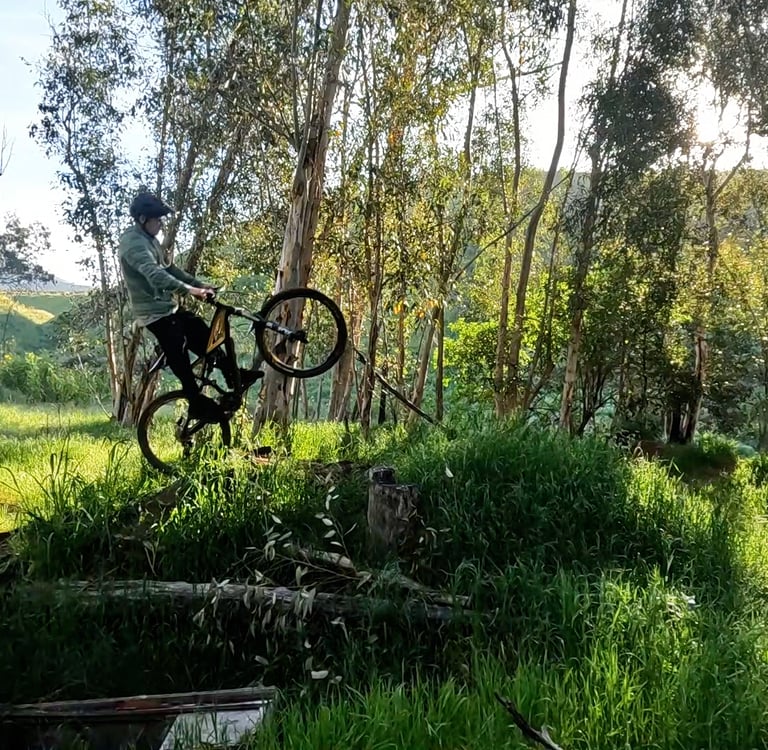 mountain biker lifting front wheel off a jump