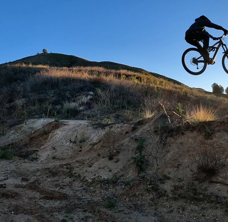 mtb rider in the air getting the arc by leveling out the bike
