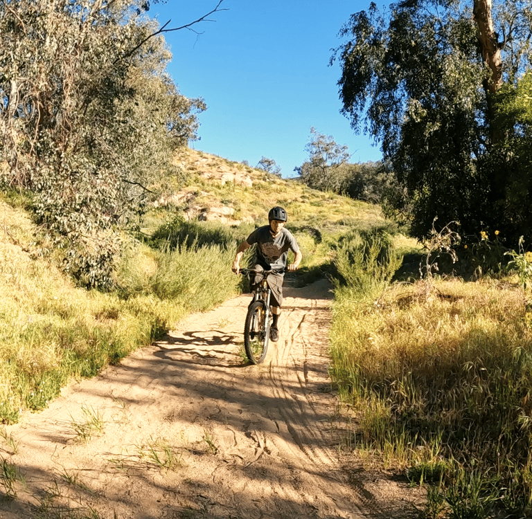 mountain biker riding through sand