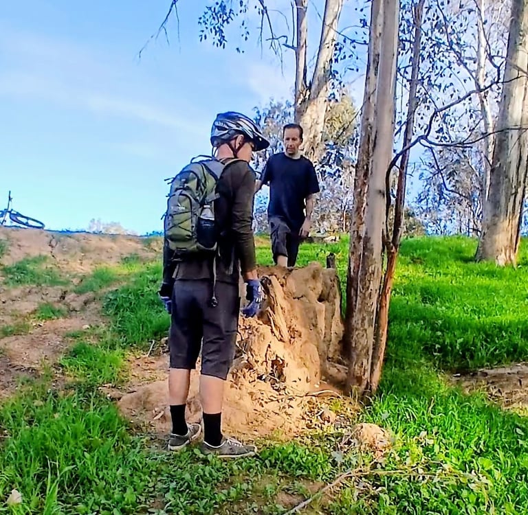Mountain biker standing wearing a hydration backpack