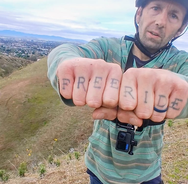 mountain biker with free ride tattoo 