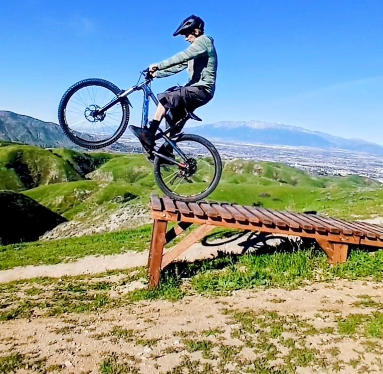 mountain biker riding off drop