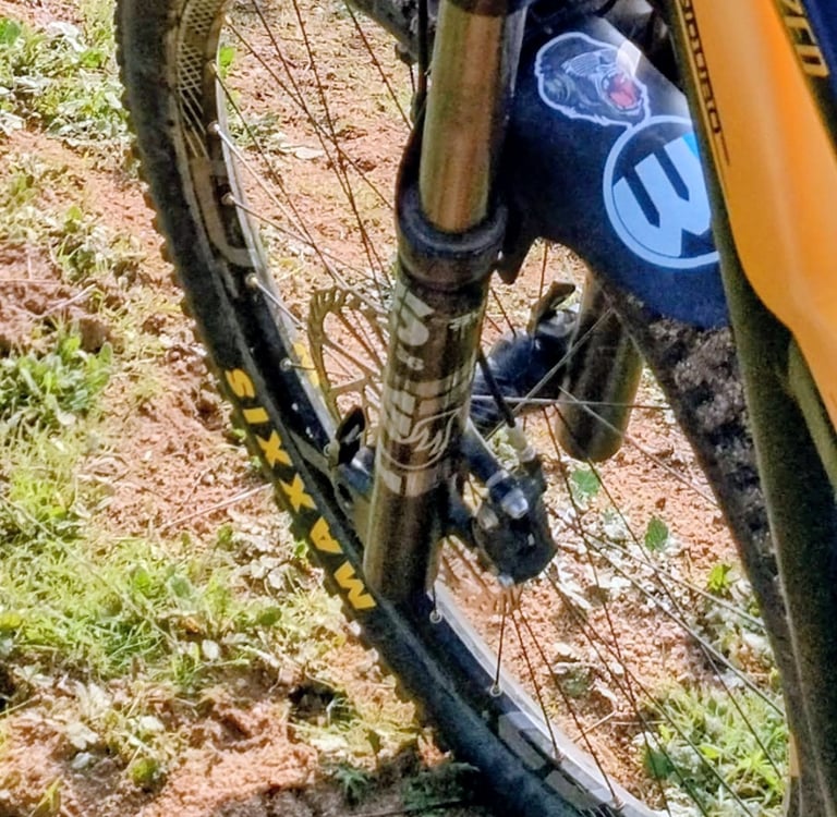 Close up of Maxxis mountain bike tire on Specialized bike on dirt trail in Southern California