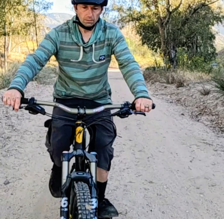 Mountain biker not wearing gloves on a hot morning ride.