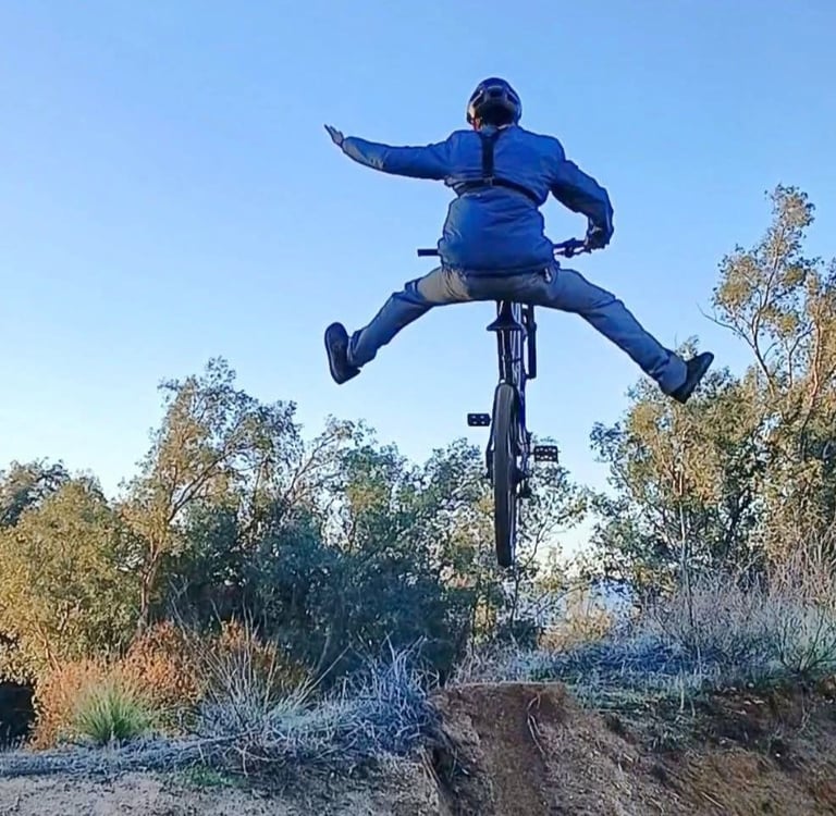 mountain biker doing a no footer one hander