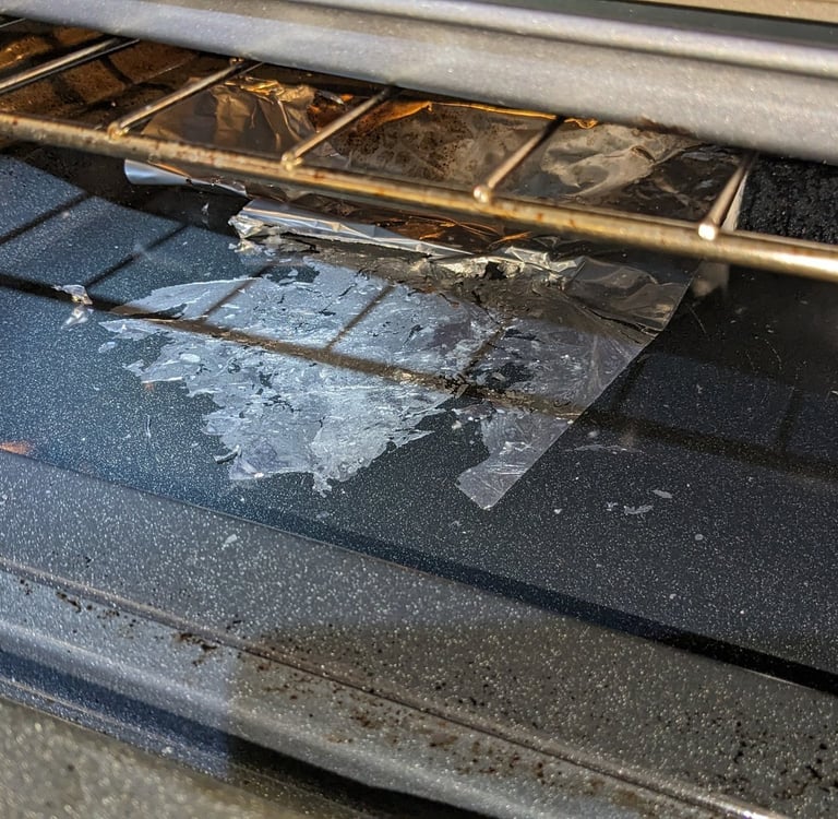Burnt aluminum folio inside a stove