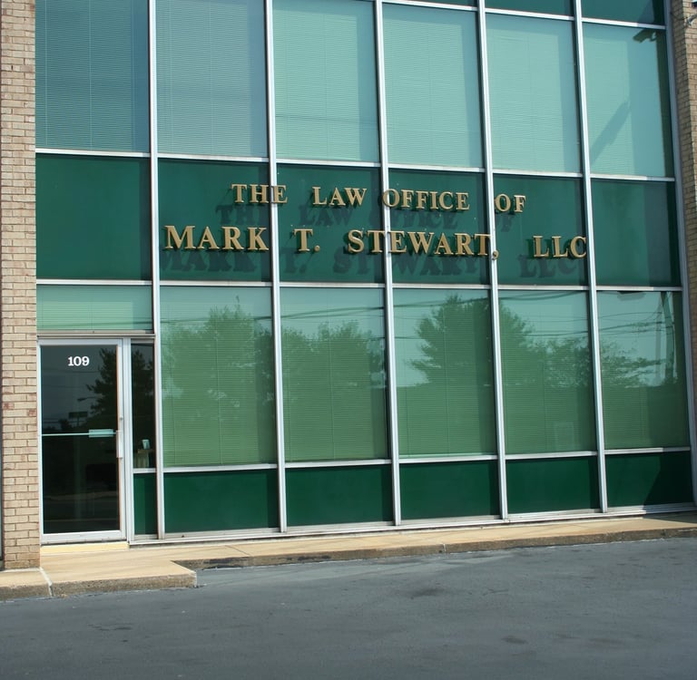 a building with a sign that says the law office of Mark T. Stewart
