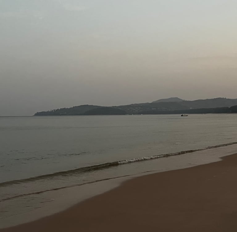 Bang Tao beach at sunrise with the mountains in the background