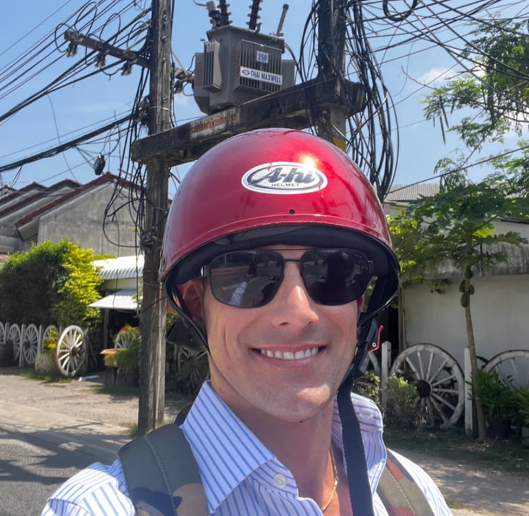 Travel writer Rick Silvia rides a scooter in Thailand