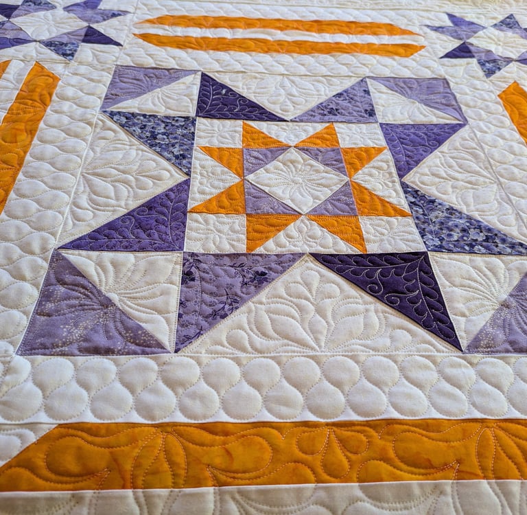 part of an orange and purple quilt