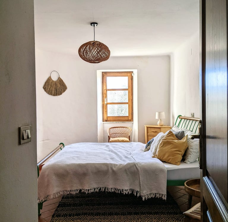 a bedroom with a bed and a chair