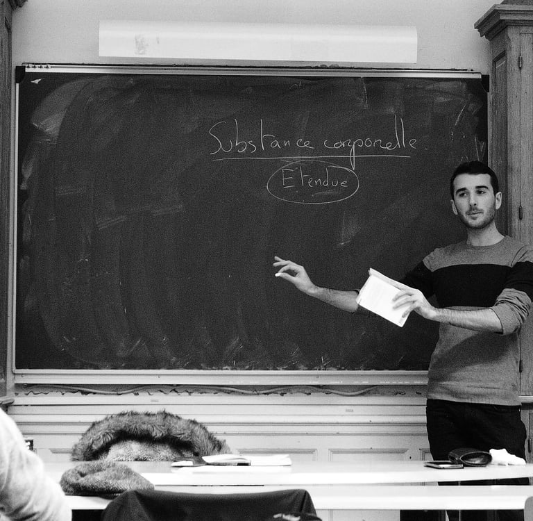 a man standing in front of a chalkboard with a blackboard