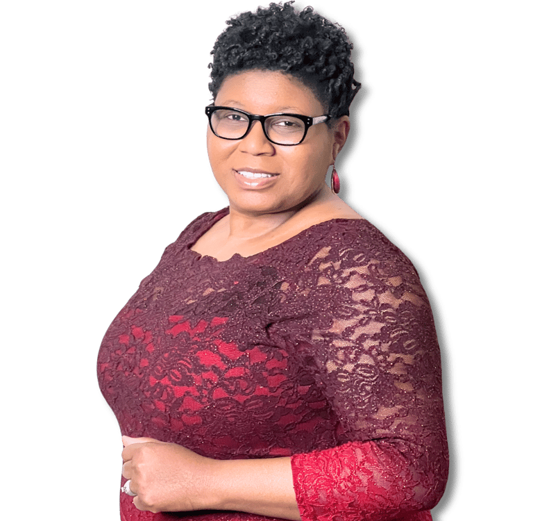 Tameka Chapman smiling in burgundy dress and black glasses