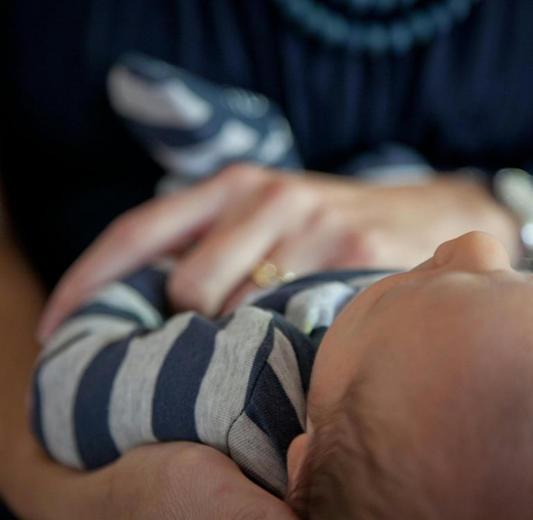 baby held by two hands