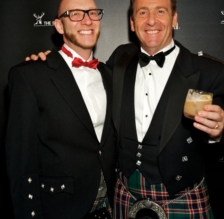 two men in kilts and happy and enjoying an event