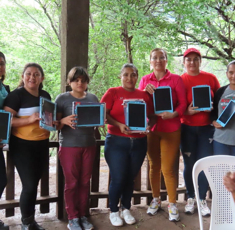 Teachers stand together in a line, presented with tablets.