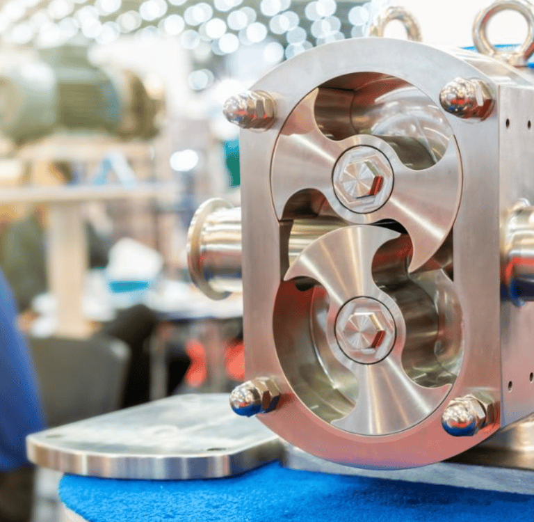 Industrial stainless steel rotary lobe pump for food and chemical fluid processing.