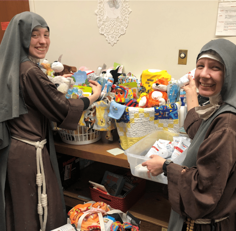 Sisters assembling new baby welcome baskets