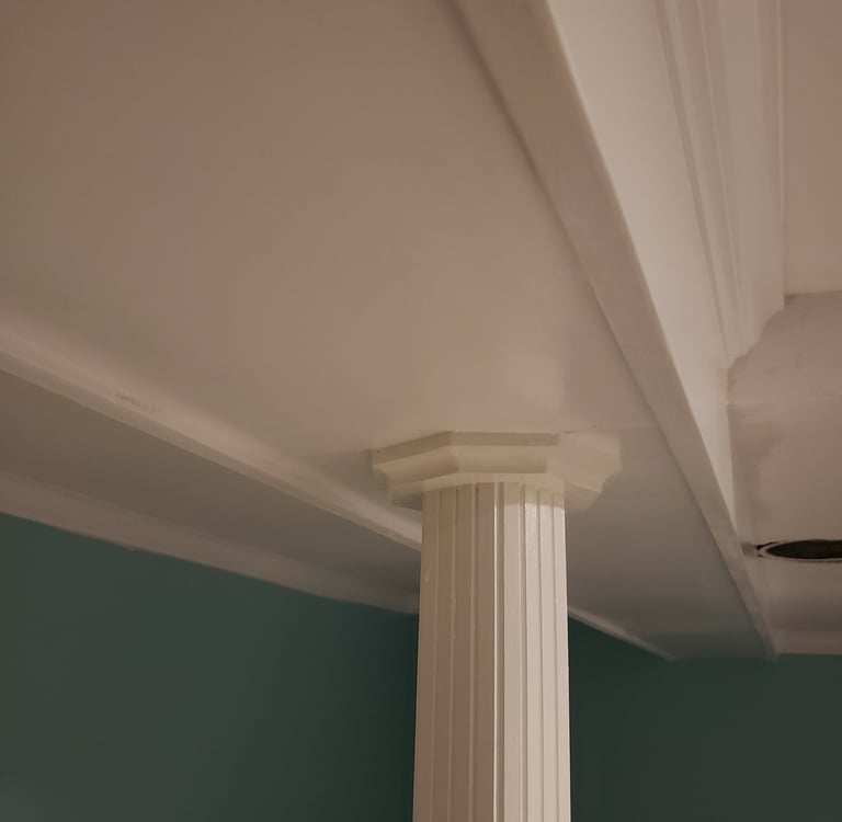 a column with a ceiling fan and a fan