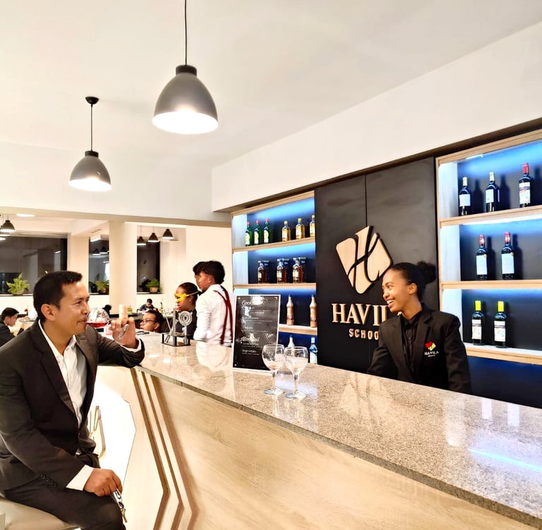 a man in a suit and tie is sitting at a bar