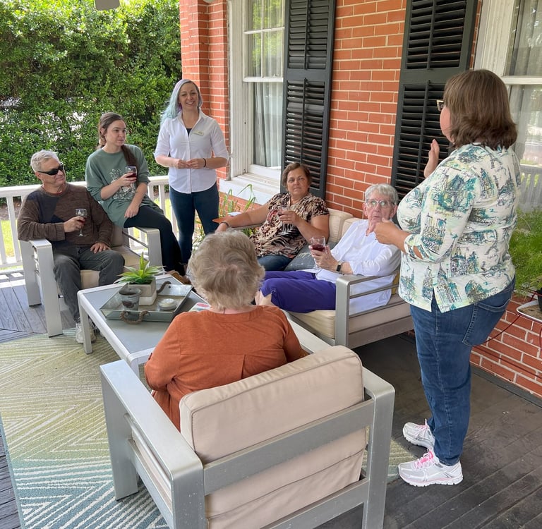 a group of people sitting on a porch