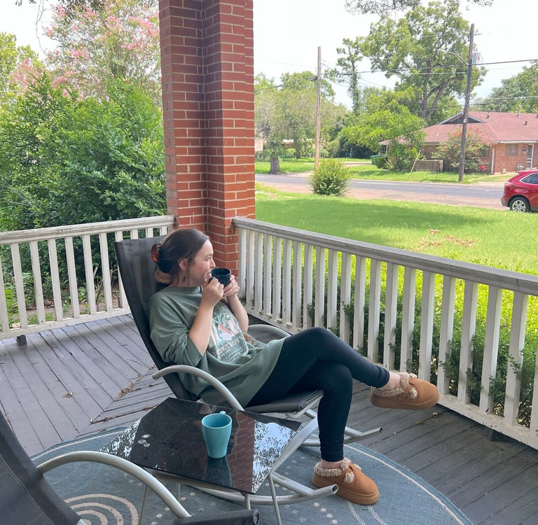 Woman sitting drinking coffee at Main Street House