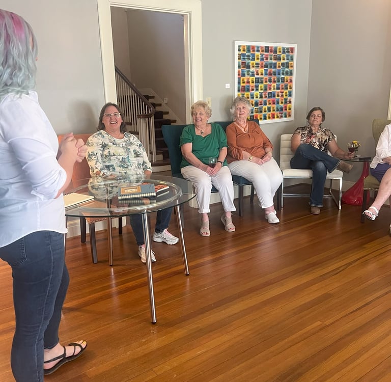 Tabitha with butterfly effect consulting talking to a group of clients at Main Street House