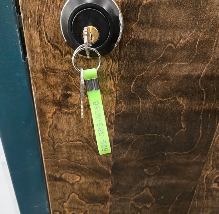 Key in a door lock with a green key tag