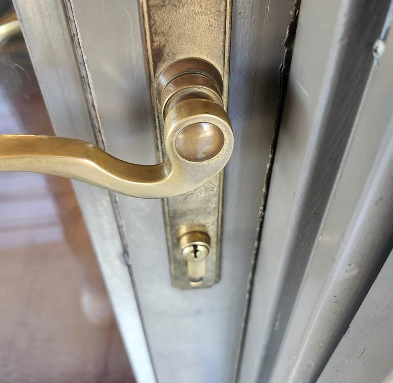 A close up of a gold doorknob on a residence door