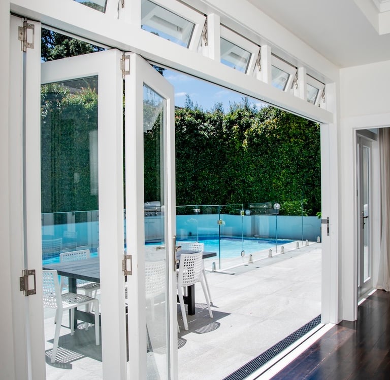 Stacker doors for indoor outdoor flow - Qualitas Builders