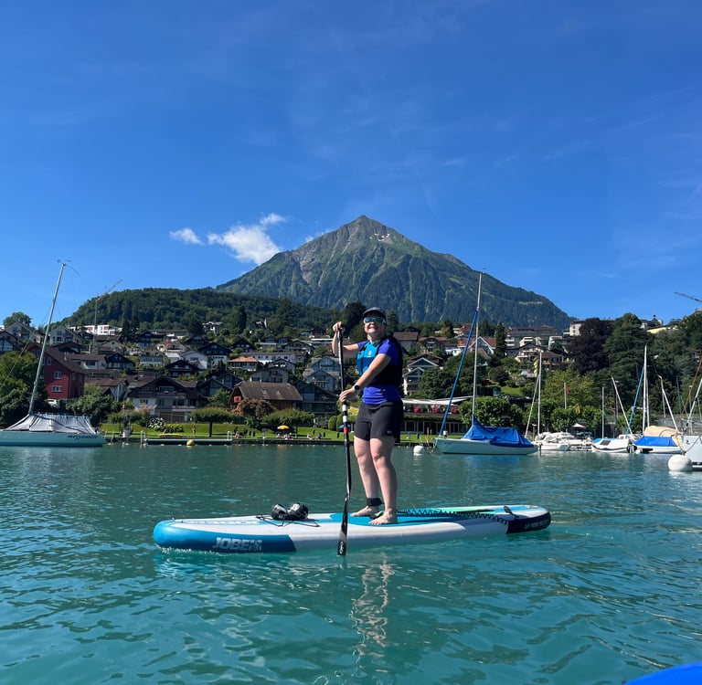 Corinne from Hidden Switzerland Travel Paddling in Spiez Bay