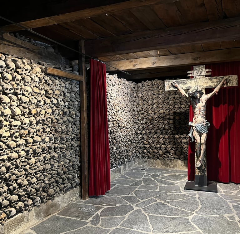 Skulls stacked floor to ceiling in the Leuk Beinhaus/Leuk Ossuary
