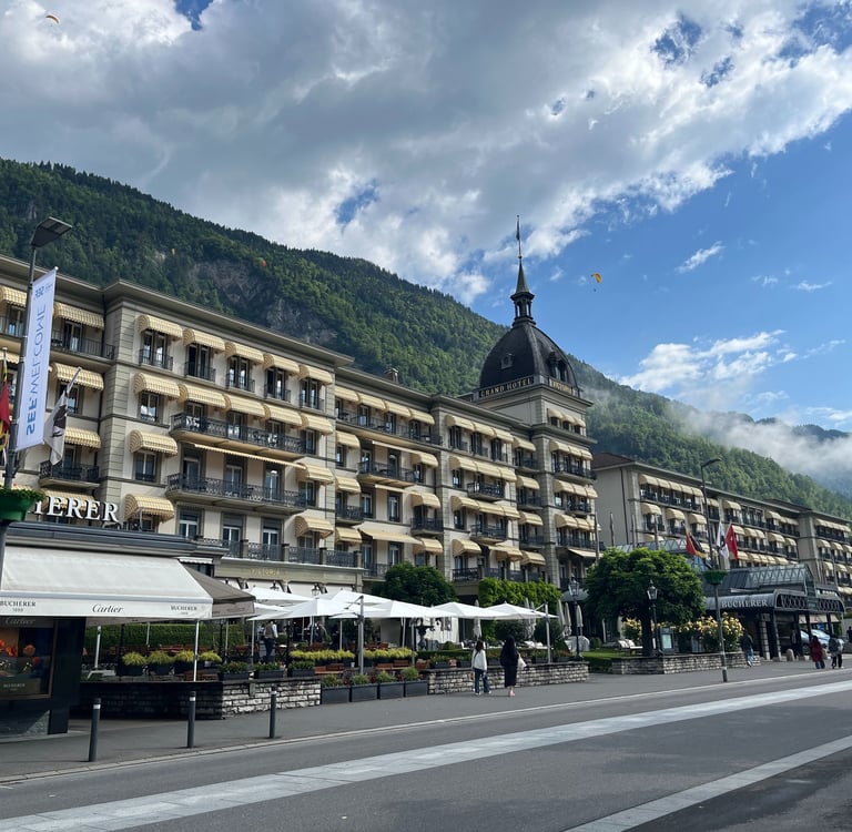 Victoria Jungfrau Hotel in Interlaken Switzerland with paragliders over head