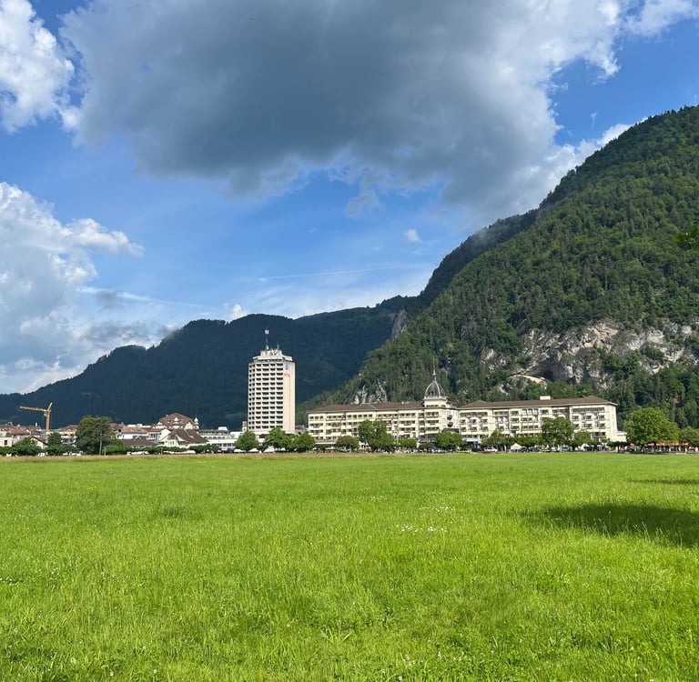 Looking across the Höhematte at Hotel Metropole and Victoria-Jungfrau in Interlaken Switzerland