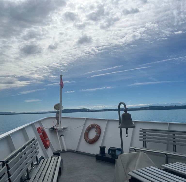 The Swiss and French Alps far off in the distance from a boat on Lake Neuchâtel